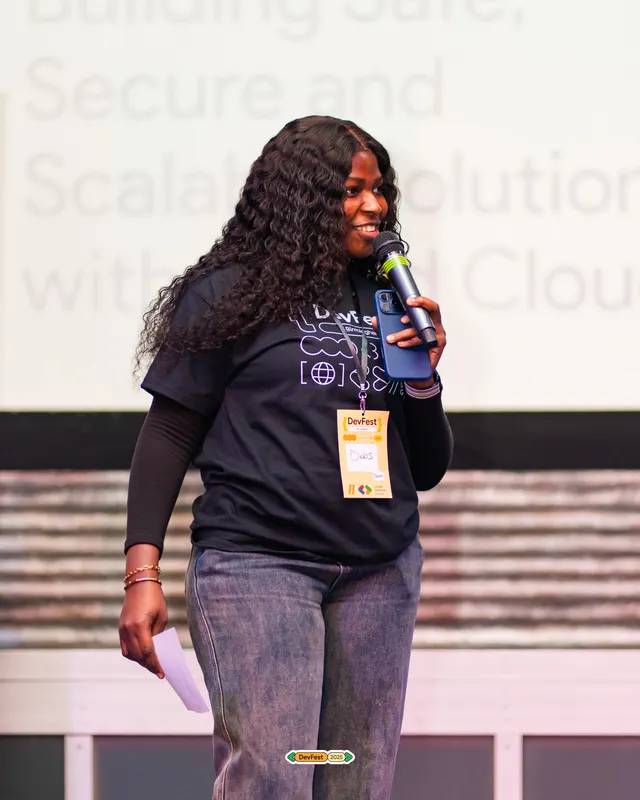 A speaker presenting on stage at a technology event