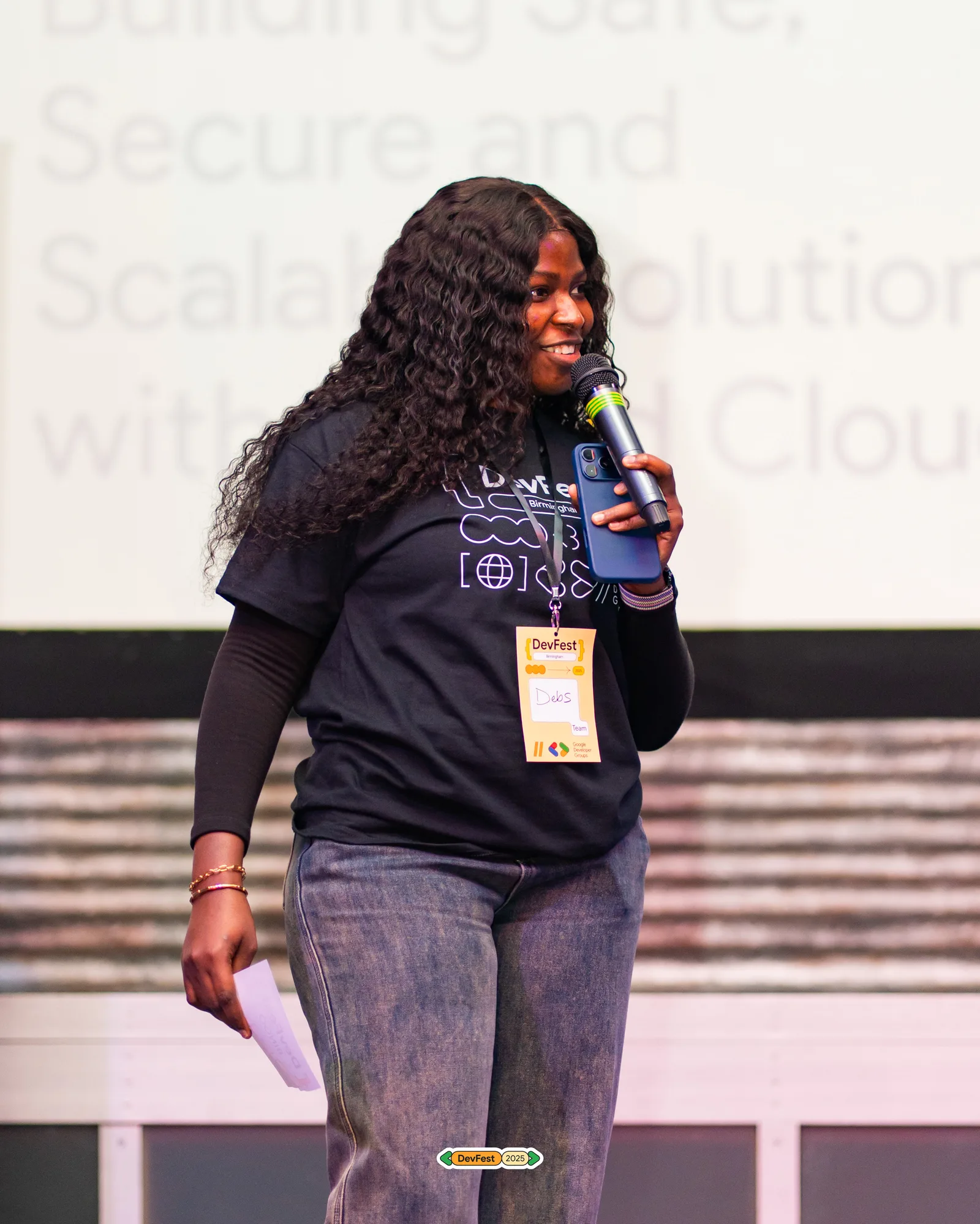 A speaker presenting on stage at a technology event
