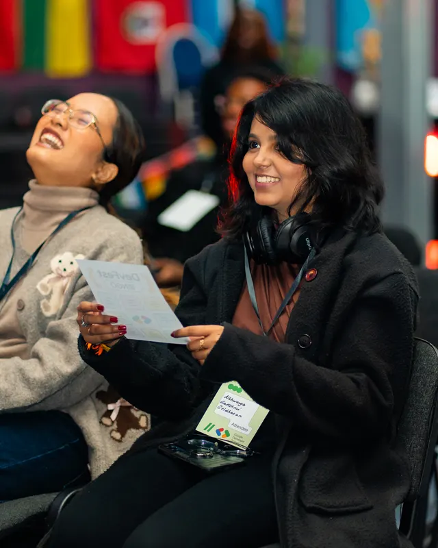 Guests laughing together during a conference