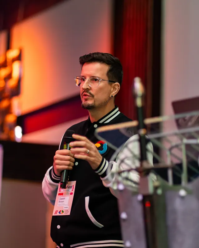 A speaker holding a microphone during a presentation