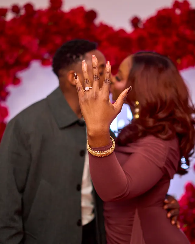 A newly engaged couple showing the ring
