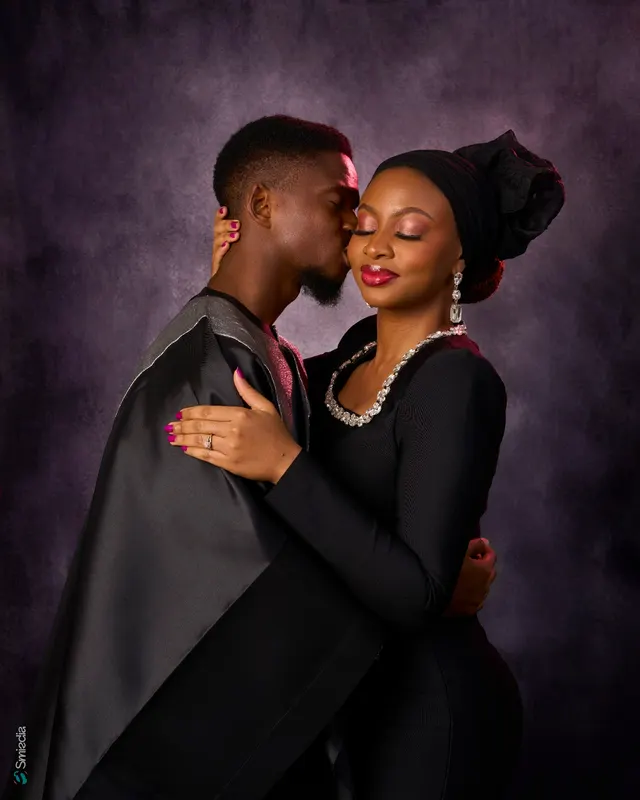A couple in coordinated black outfits
