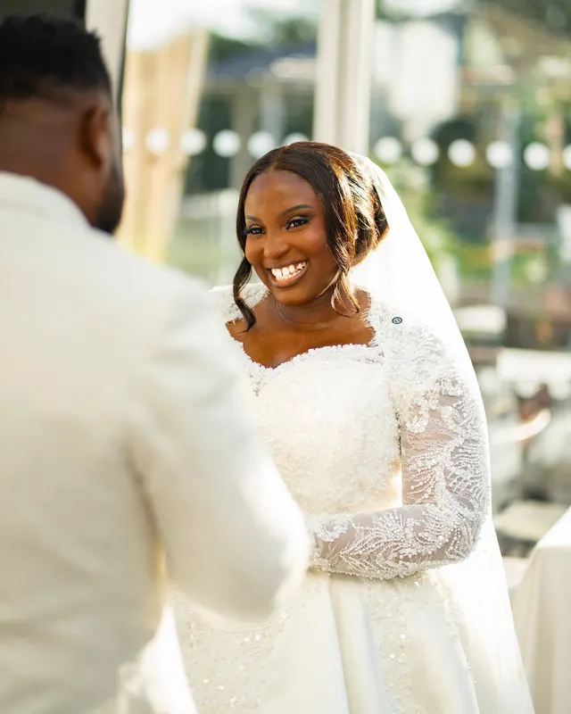 A bride smiling at the groom during their ceremony