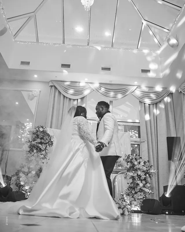 A black and white portrait of a couple dancing