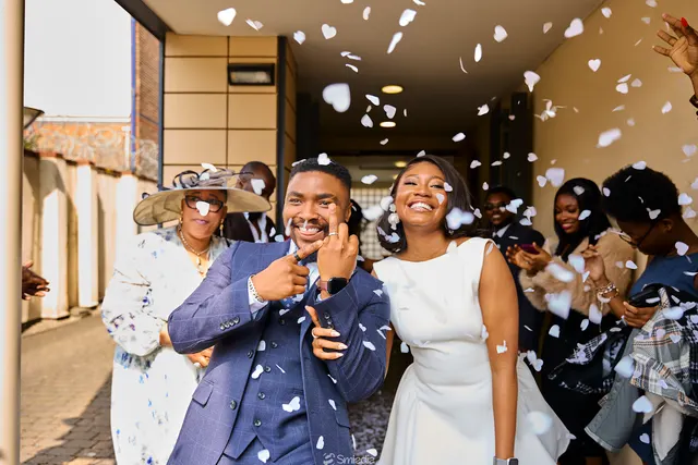 Newlyweds celebrating beneath falling confetti