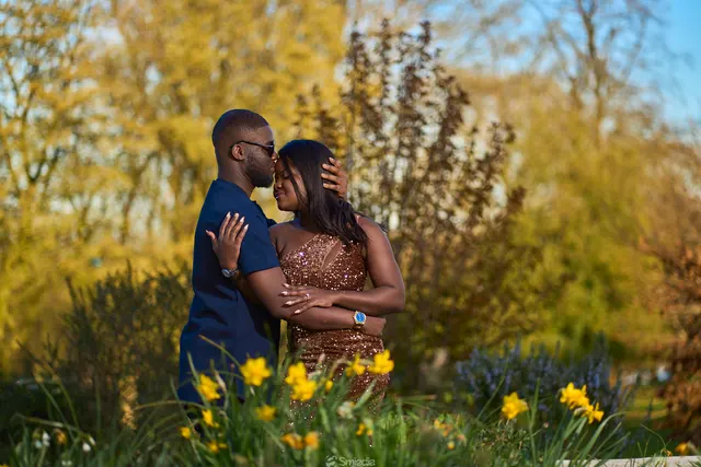 A couple embracing among daffodils
